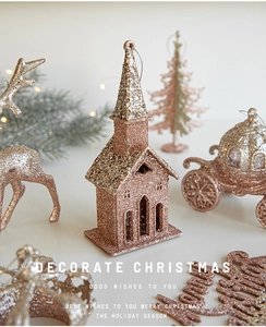 Close-up of rose gold glitter Christmas ornaments featuring reindeer and house designs