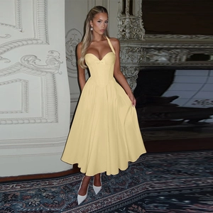 Detail view of light yellow halter neck corset dress with a flared A-line silhouette