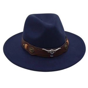 Detail of navy fedora hat featuring brown leather band and silver bull skull ornament
