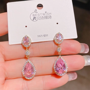 Detail of pink teardrop pendant earring with S925 silver needle on display card