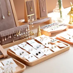 Elegant jewelry display collection with wood trays and velvet stands for necklaces and earrings