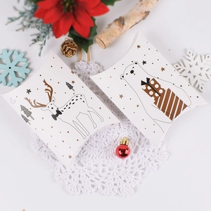 Christmas pillow gift box featuring festive reindeer and polar bear illustrations on white paper