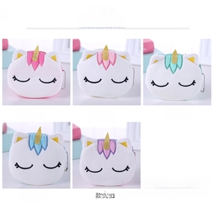 Detail view of five unicorn plush coin purses with gold horns and embroidery