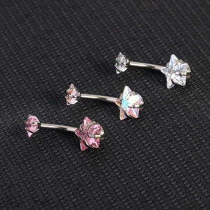 Star-shaped zircon belly rings in white, pink, and iridescent stainless steel colors