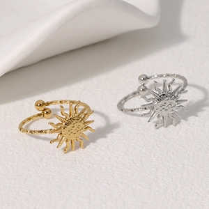 Detail of adjustable sunburst rings in gold and silver with textured face and rope band