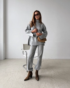 Chic light gray high neck knit sweater paired with brown leather crossbody bag and pointed boots