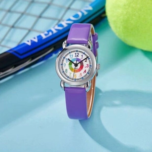 Close-up of children's quartz watch with purple strap and silver case on tennis background