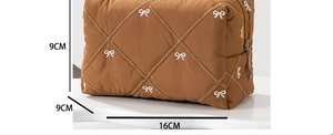 Brown quilted makeup bag with white bow embroidery and dimensions 16cm x 9cm x 9cm