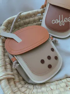 Detail of cute milk tea cup shaped PU leather crossbody bag with coffee embroidery and strap