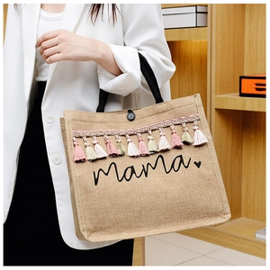Detailed macro of large jute tote with colorful tassels and black Mama print text