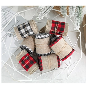 Macro shot of buffalo plaid edge jute ribbons in metal basket for Christmas gift wrapping