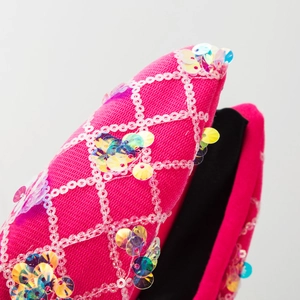 Pink sequin knot headband with sparkling rhombic pattern and colorful glitter accents