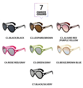 Collection of seven oversized fashion sunglasses in various colors on white background