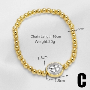 Close-up of 18k gold-plated beaded bracelet with a four-leaf clover round charm detail