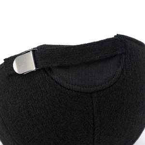 Detail of winter baseball cap showing thick knitted texture and metal adjustment buckle