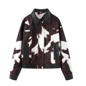 Short cow print bomber jacket with black leather trim and plush faux fur texture