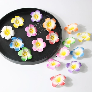 Tropical plumeria flower hair clips with central pearl accents in vibrant assorted colors