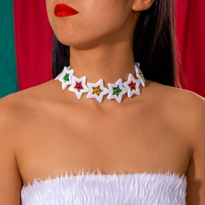 Close-up of festive lace choker with pearl stars and colorful Christmas bells on model