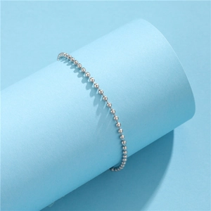 Minimalist silver 304 stainless steel round bead chain bracelet on a light blue display