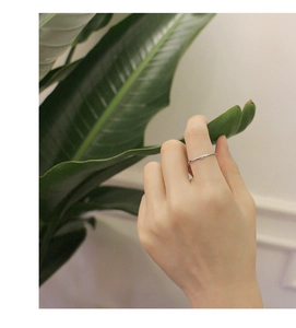 Minimalist S925 sterling silver thin ring with single zircon on hand in nature setting