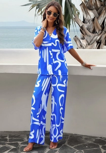 Close-up of elegant blue two-piece floral set with button-down shirt and loose trousers