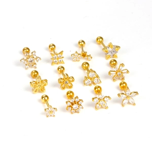 Macro detail of 12 gold stainless steel stud earrings set with zircon stones