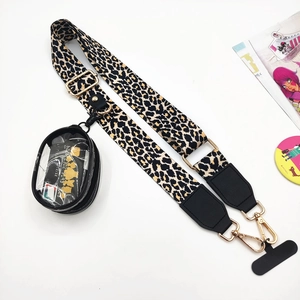 Detail of adjustable leopard print strap with a clear PVC mini pouch and golden hooks