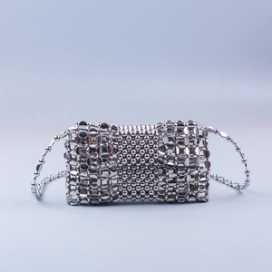 Detailed view of silver woven metal bead crossbody bag with sleek chain strap
