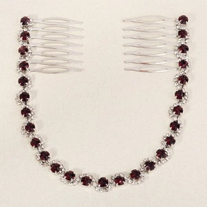 Detail of silver bridal hair comb set with deep red rhinestones and crystal chain