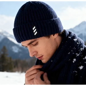 Close-up of thick rib-knit pattern and woven label on navy blue winter beanie and scarf set