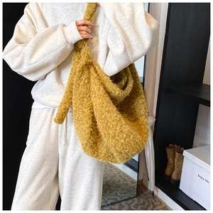 Detailed macro view of yellow plush fabric texture on a soft oversized tote bag