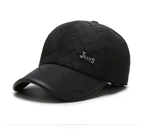 Detail view of black quilted baseball cap featuring diamond stitching and metal logo