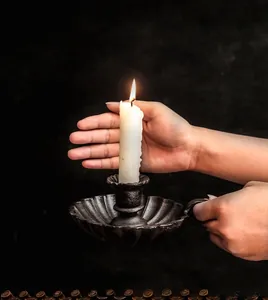 Vintage bronze cast iron candle holder with shell-shaped base and ergonomic handle