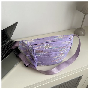 Detail of lavender embroidered waist bag with textured wave pattern and adjustable strap