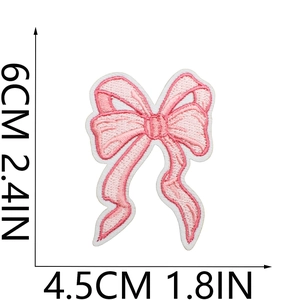Pink bow embroidery patch detail with dimensions 6cm by 4.5cm on white background