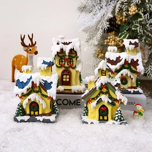 Set of four resin glowing Christmas village houses with snowy roofs and mini trees