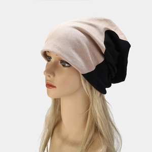 Autumn two-tone knit beanie in pink and black on mannequin with a slouchy fit