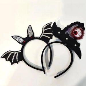 Detail of Halloween headbands featuring silver bat wings and purple spider web elements