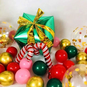 Detailed view of Christmas balloon arch with gift box and candy cane foil balloons