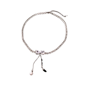 Sparkling zircon bow necklace with elegant pearl tassels on a silver chain choker