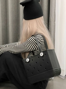 Detail of black waterproof EVA beach tote with perforated holes and side handle view