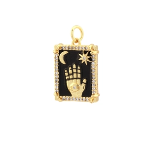 Detailed view of 18k gold plated Hamsa hand pendant with black enamel and zircon inlay