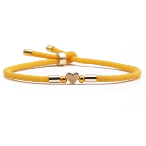 Adjustable yellow braided cord bracelet with gold heart charm and metallic beads