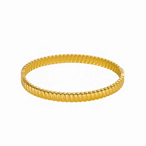 Textured 18K gold plated stainless steel open bangle bracelet with a wavy ripple design