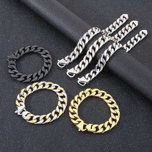 Flat lay of Cuban chain bracelets in silver, gold, and black colors on dark texture