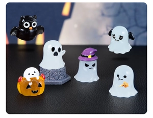 Detailed view of Halloween resin figurines including ghosts and owl on black leather