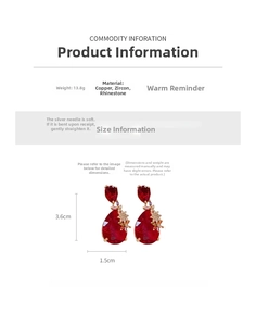 Detail view of drop earrings featuring red zircon and colorful floral crystal accents