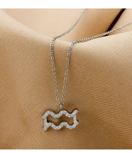 Macro detail of silver Aquarius zodiac necklace featuring micro-pave cubic zirconia crystals