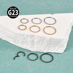 Solid G23 titanium septum rings with zircon stones in silver, gold, and black finishes