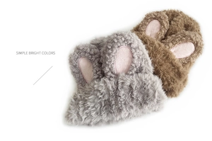 Detailed texture of fuzzy rabbit ear knit hats in grey and brown soft faux fur